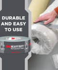 Person using Heavy Duty Duct Tape 1.88 in x 45 yd (2 Rolls) to seal a rolled carpet, showcasing its multi-surface adhesive.