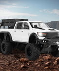 Tough As Nails 1 To 24 Diecast Off Road Pickup Toy Truck With Light And Sound, Metal Construction, White 6x6 vehicle on rocky terrain.