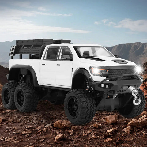 Tough As Nails 1 To 24 Diecast Off Road Pickup Toy Truck With Light And Sound, Metal Construction, White 6x6 vehicle on rocky terrain.