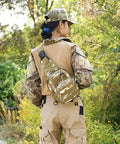 Person outdoors wearing waterproof tactical crossbody backpack with MOLLE system, 600D Oxford fabric, military camouflage pattern.