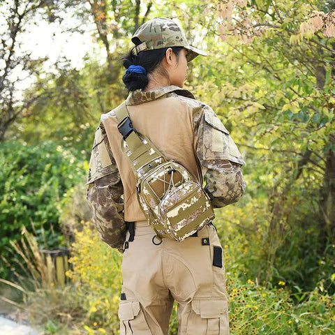 Person outdoors wearing waterproof tactical crossbody backpack with MOLLE system, 600D Oxford fabric, military camouflage pattern.