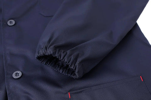 Close-up of navy blue rugged lab coat for men with elastic cuff, perfect for DIY and workshop jobs, size large, poly-cotton fabric.