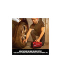 Man using V20 Tire Inflator Portable Air Compressor With Cordless 120V Corded And 12V Car Adapter Modes on car tire in garage