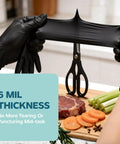 Solid Black Nitrile Gloves One Hundred Count Large Heavy Duty Powder Free Latex Free gripping food while cutting with scissors.