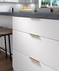 Modern kitchen with Lincoln Collection 5 1/16 Inch Center To Center Brushed Champagne Bronze Cabinet Handles installed on white drawers