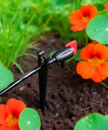 100 Pieces Drip Irrigation Stakes For 1/4 Inch Tubing, 5.68 Inch Long Plastic Stakes in garden with vibrant flowers