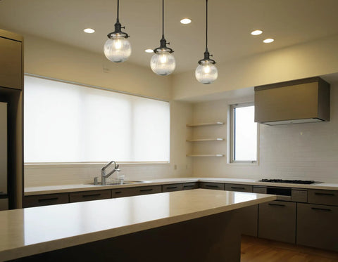 Three Light Linear Pendant Island Lighting With 5.9 Inch Globe Striped Glass Shades installed in a modern kitchen.