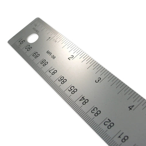 Close-up angle of Stainless Steel Ruler With Non Slip Cork Base 6 Inch For Pro-Grade DIY Crafting And Drafting Warp Free And Bend Resistant Measuring Tool With Easy Read 1/16 And Metric Markings For Clarity showing clear etched markings