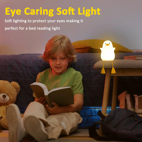 Child reading beside Seagull Silicone Night Light for Kids Portable Rechargeable Bedside Lamp for Nursery with Touch Control