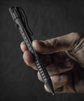 Hand holding All Weather Readiness Metal Tactical Pen With Bolt Action Clicker Glass Breaker Tip Heavy Duty Aluminum Body Black Ink