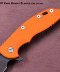 Close-up of orange G10 knife handle example with CNC texturing on a knife against a textured background.