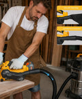 Badass Cordless Brushless Belt Sander With Six Variable Speed Settings And Raw Grip being used to smooth wood with vacuum attachment.