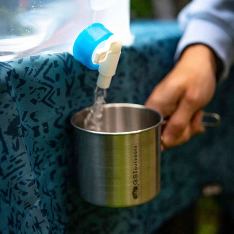 All-In-One Stainless Steel Cup And Pot, 24 Oz, Lightweight, being filled with water for camping and outdoor use