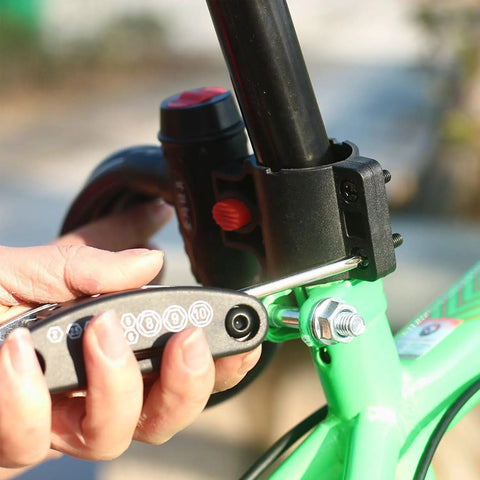 Using Bike Repair Tool Kit 16 In 1 For Quick Fixes With Glueless Tire Patches And Tire Levers in a compact case on a green bike.