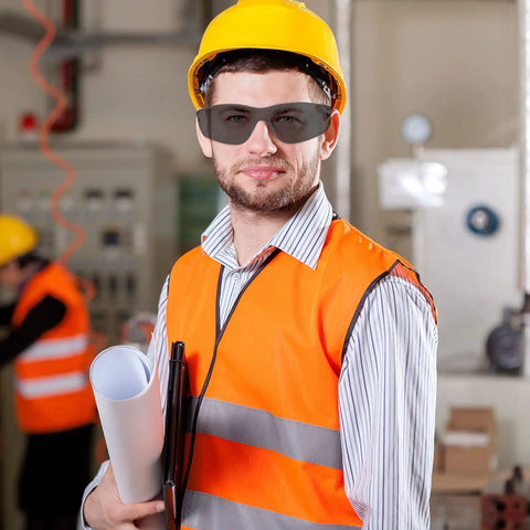 Kickass Wraparound Safety Glasses Bulk Pack For Men And Women Sporting Clear Polycarbonate Lenses worn by a man in a work environment.