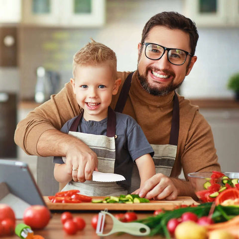 Montessori kids kitchen knife set, 13-piece wooden knives with plastic toddler blades, cutting vegetables in a kitchen.