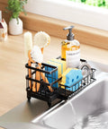 Auto Draining Sponge Holder For Kitchen Sink With Detachable Rack And High Brush Holder, 360 Degree Rotatable Spout Channels Water To Sink, Keeps Countertop Dry, No Soggy Sponges, Hygienic Caddy Organizer For Kitchen Storage, Black shown with brushes and sponges.