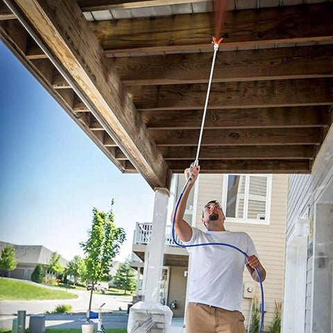 Man using Built Tough Airless Paint Spray Gun With Nozzle Guard For Pump Sprayer 3600 Psi to spray under a wooden structure.