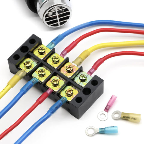 Front view of black screw-terminal block with color-coded heat-shrink wire connectors and nearby ring/spade terminals.