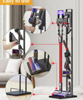 Dyson Vacuum Stand And Cordless Vacuum Accessory Organizer For V15 V11 V10 V8 V7 V6 And DC30 DC31 DC34 DC35 DC58 DC59 DC62 DC74 Heavy Duty Metal Storage Holder For Home Garage And Kitchen Black displayed in a living room.
