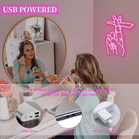 Woman using makeup with Pink LED Hand Neon Sign For Wall Decor USB Powered Nail Room And Girls Room Neon Light glowing in room.