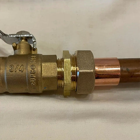 Real Solid 3/4 Inch Brass Pipe Union Fittings Three Pack Copper To Male Thread Sweat Plumbing Connectors visible with a valve and copper pipe.