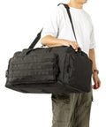 Person holding a 60L Heavy Duty Duffel Travel Bag With Waterproof 900D Exterior And Foldable Design Durable Black Gear Bag.