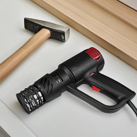 Go To Heat Gun Safety Cap And Cage Guard With Heat Resistant Cover For Crafting And DIY Projects Universal Fit Easy Install Burn Protection For Hot Air Machines on a table next to a hammer.