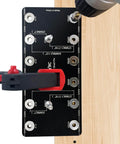 Aluminum Shelf Pin Drilling Jig For One Quarter Inch And Five Millimeter Holes, showing top view mounted on wood with drill.