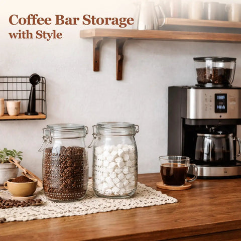 Glass Canister Set 34 Oz Each, 3 Pack Clear Jars For Coffee Bar Countertop, filled with coffee beans and sugar cubes.