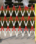 Rock Solid Retractable Scissor Gate With Hella Bright Yellow And Black Reflective Strips Smooth Gliding Industrial Barrier for Driveways.