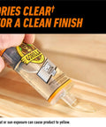 Gorilla 2-part clear epoxy syringe dispensing onto a wooden surface