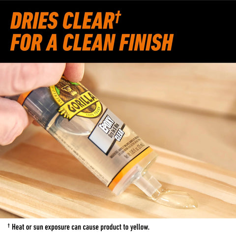 Gorilla 2-part clear epoxy syringe dispensing onto a wooden surface