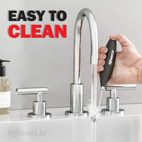 Person holding Powerful Handheld Milk Frother With Stand Battery Operated Foam Maker Wand under faucet for cleaning