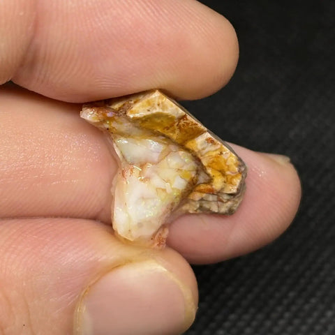 Close-up of Spencer Idaho Pink Opal Rough Cutting Material Dope Multicolor Loose Gem 70.80 Cts 11x8x5 mm in hand