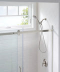 Five Function Handheld Shower Head With Brushed Nickel Spot Resistant Finish in a modern bathroom setting.
