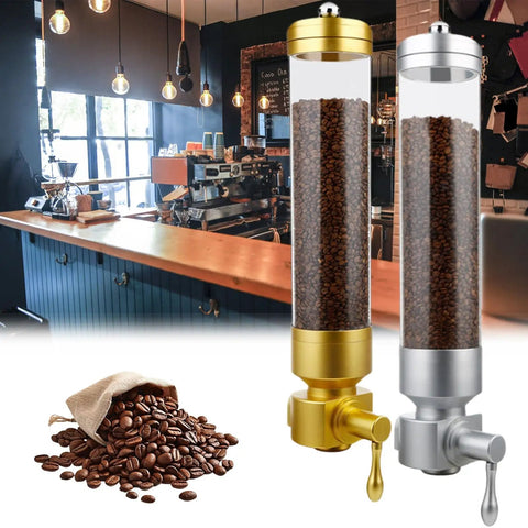 Wall Mounted Coffee Bean Dispenser With Hella Spacious Large Capacity Transparent Acrylic Jar In Slick Gold Finish For Busy Commercial Shops And Top Shelf Home Bars beside a burlap sack of coffee beans.