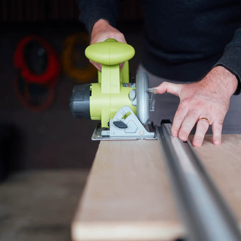 Dead On Aluminum Straight Edge Guide For Table Saw And Router Jig With Heavy Duty Grip Clamp And 24 Inch Fence in use with a cutting tool on wood surface.