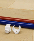 1 Inch PEX Pipe Support Hangers Set Of 130 U Hook PVC Clamps for Water Lines with red and blue pipe on stone floor