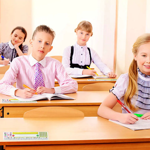 Students in a classroom using 40 Pack Transparent Self Adhesive Nameplate Pockets 14.5 by 4.5 Inch for Desk Name Tags Thick 7 Mil Durable Mounting Sleeves for Easy Display and Quick Replacement on their desks.
