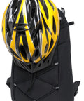 Lightweight Insulated Hydration Backpack With 2L Or 3L Water Bladder For Hiking, Trail Running, Cycling And Race Day shown with helmet attached