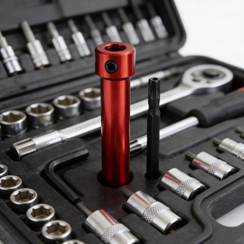 Front view of red steel coupling sleeve socket adapter in a tool set with silver sockets.