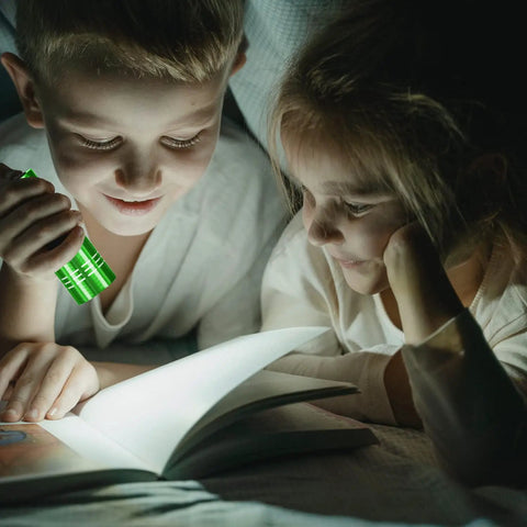 Children reading with a green flashlight from 5 Pack Dope Mini LED Flashlights Handheld Aluminum Torches With Lanyards And AAA Batteries Included Assorted Colors For Camping Power Outages Night Reading And More