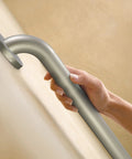 Hand holding 36 Inch Stainless Steel Handicap Grab Bar For Bathtub And Shower With Peened Grip Texture Concealed Screws