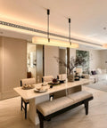 Artpad 47.24-Inch Modern Long Marble Dining Pendant Light, Suspension Lamp above a minimalist dining table in an elegant interior.