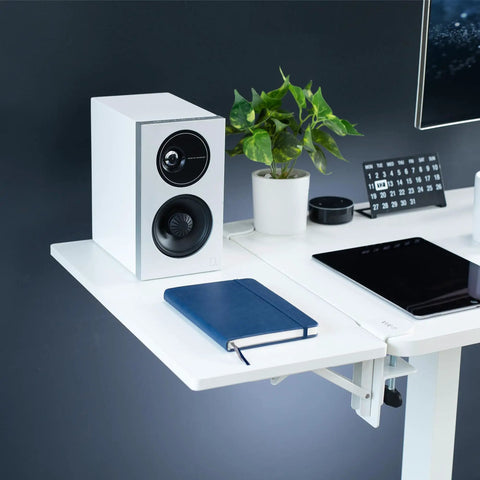 White Clamp On Desk Extender For A Sweet Home Office Upgrade Foldable Desktop Shelf with speaker, notebook, and plant.