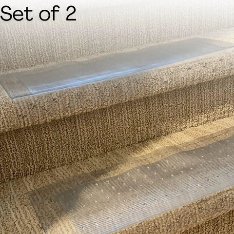 Set of 2 clear vinyl stair tread protectors 24x8 inches, on carpeted stairs, with gripper teeth to prevent slipping and protect carpet.