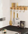 Ten Pack Vintage Metal Wall Hooks Set With Bronze Finish Boho Style Decorative Hangers holding kitchen utensils