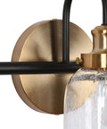 Close-up of Modern 3 Light Seeded Glass Vanity Light Fixture In Matte Black And Brushed Brass Finish With A Circular Backplate.