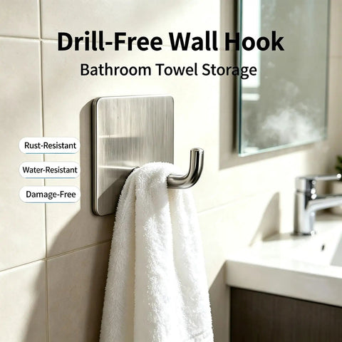 Rock Solid Self Adhesive Wall Hooks Crafted From Premium Stainless Steel For Zero Drill Wall Mounting And Effortless Home Organization With A Smooth Silver Look Set Of Four holding a towel in a bathroom.